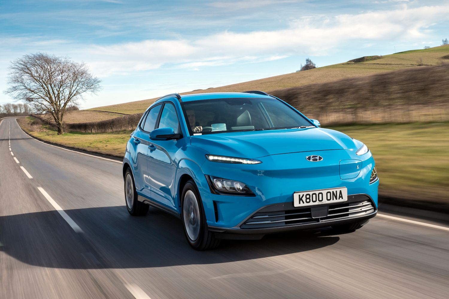 Hyundai Kona electric car driving through countryside